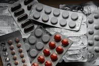 Close-up of various pills in blister packs showcasing medical and healthcare themes.